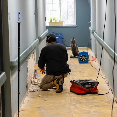 Restoration technician drying a floor in a Stamford, CT home